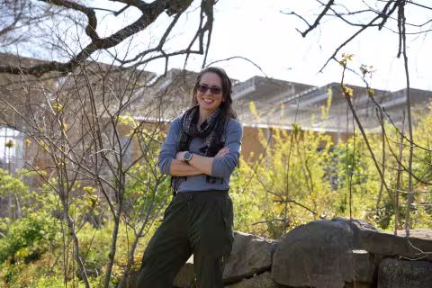 Emily Weigel standing outdoors near vegetation