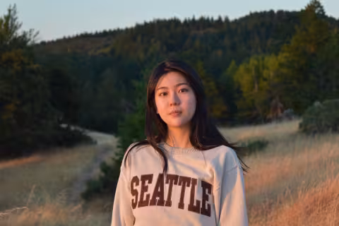 woman in sweatshirt in field