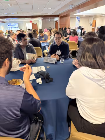 A group sits around a round table
